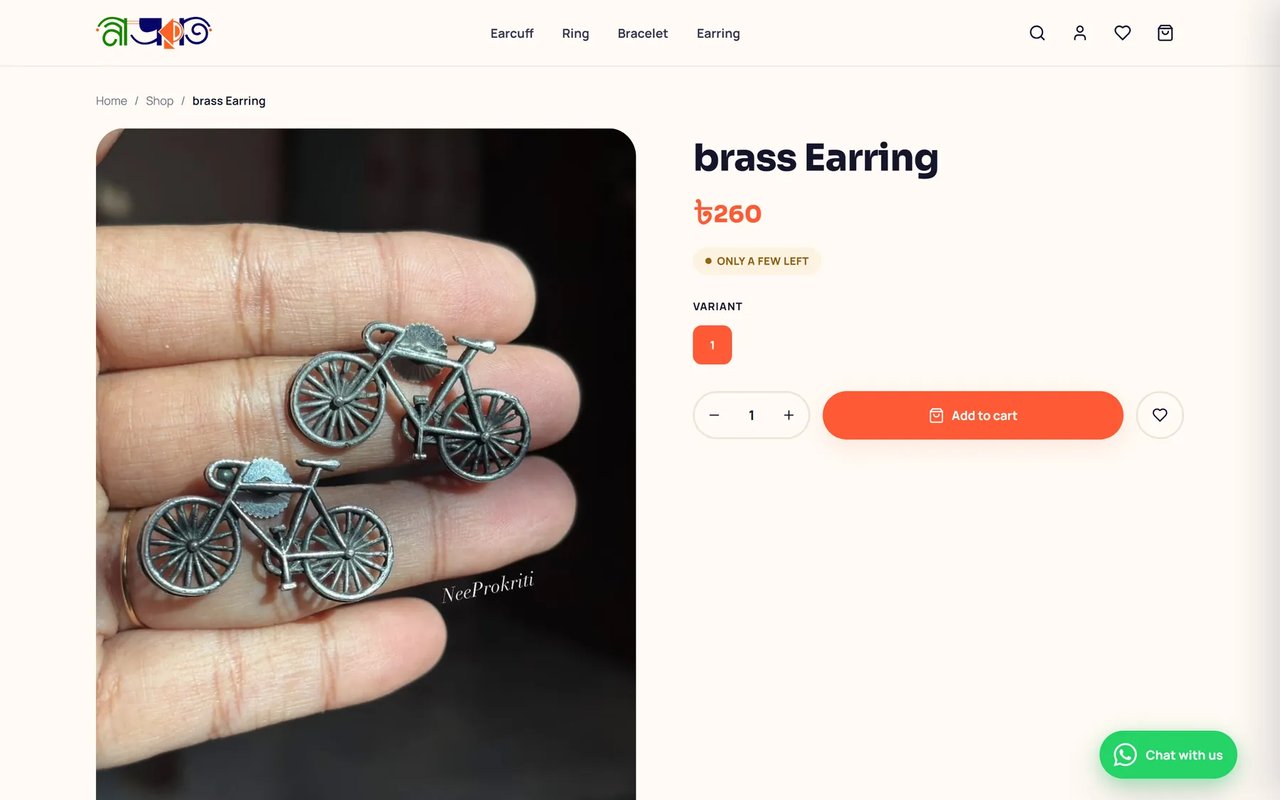 NeeProkriti product page for a pair of bicycle-shaped brass earrings at 260 taka, with an Only a few left badge, quantity stepper and Add to cart button.